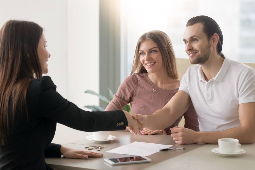 happy-couple-meeting-with-an-agent-to-sign-documents